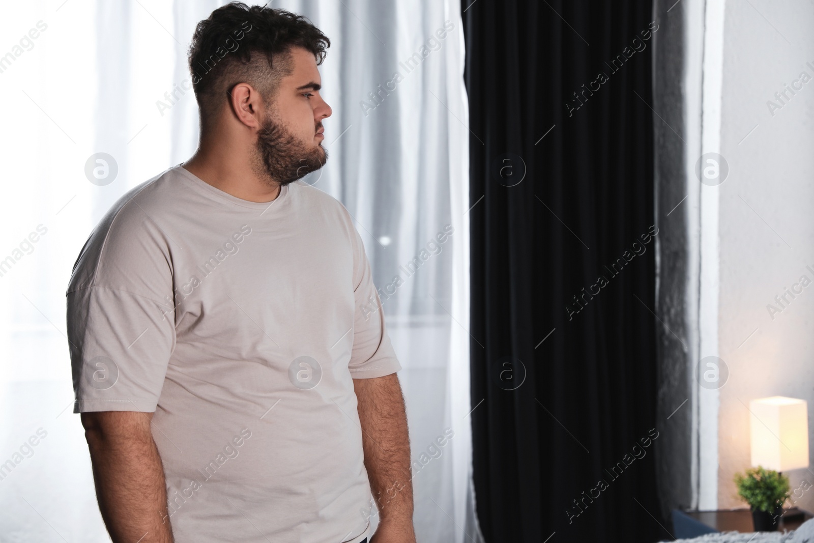 Photo of Overweight man suffering from depression at home