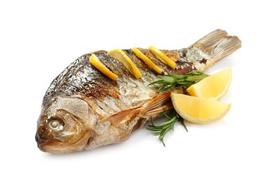 Photo of Tasty homemade roasted crucian carp with rosemary and lemon on white background. River fish