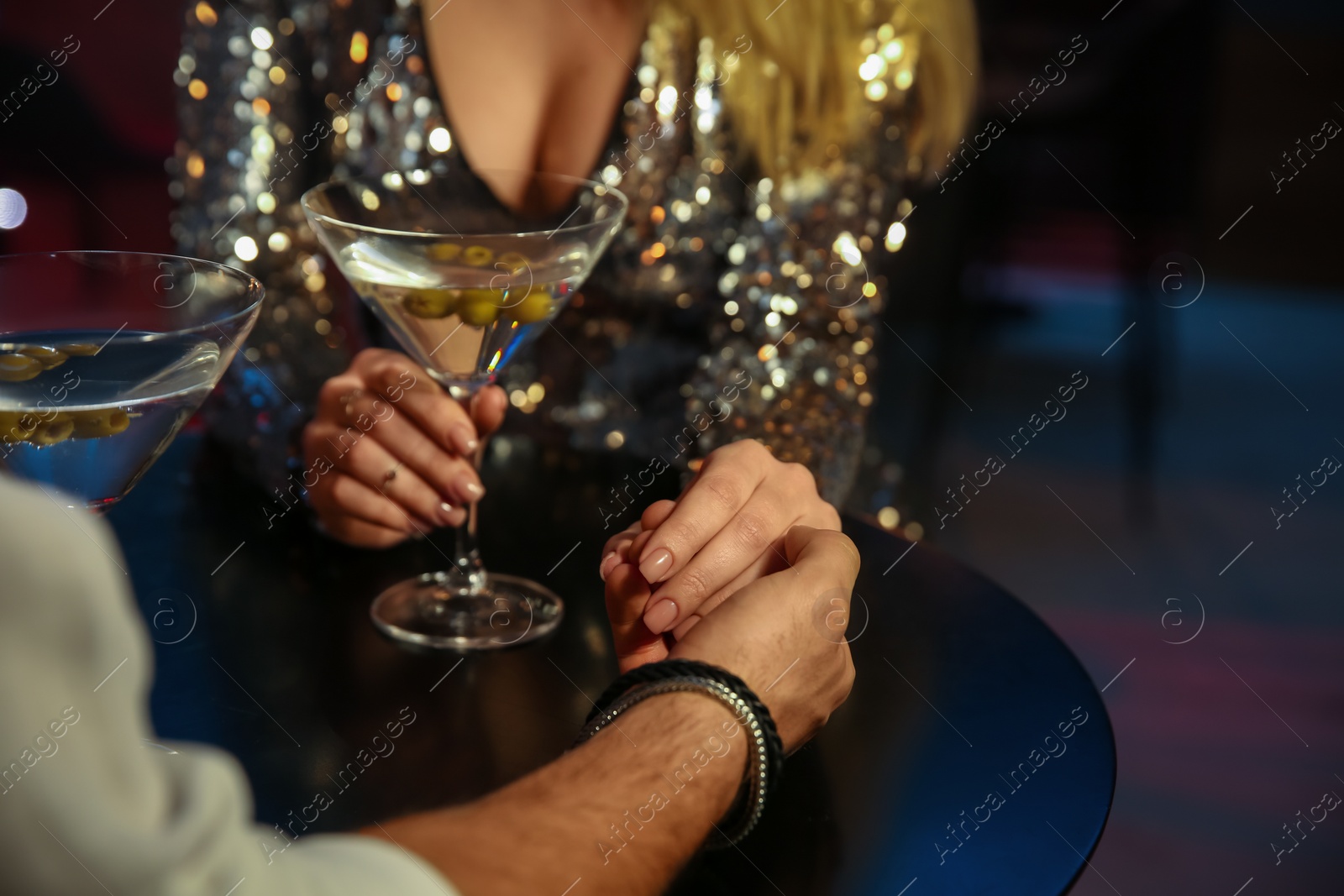 Photo of Man and woman flirting with each other in bar, closeup