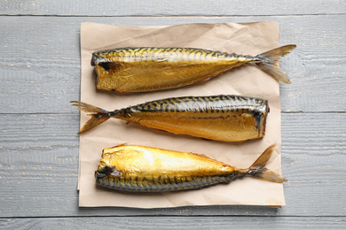 Photo of Tasty smoked fish on wooden table, top view