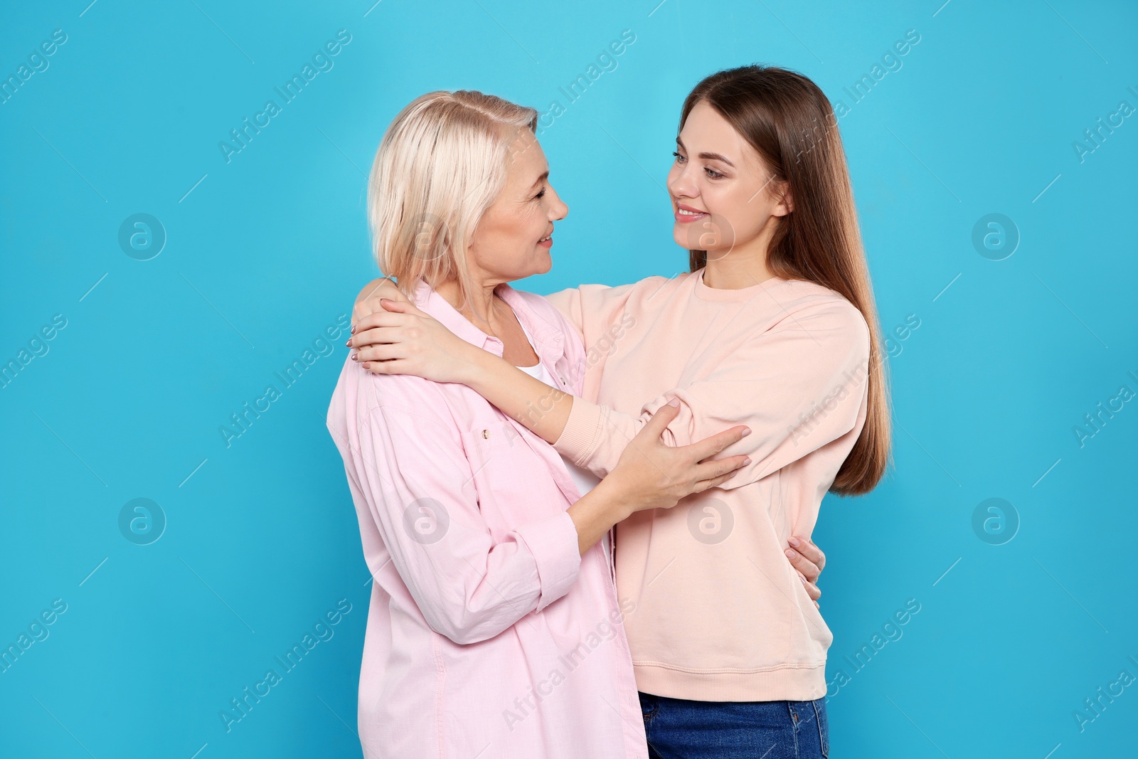 Photo of Portrait of mature woman and her daughter on color background