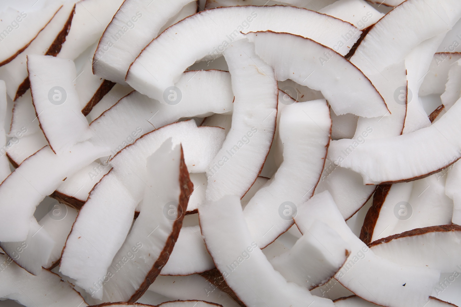 Photo of Fresh coconut pieces as background, top view