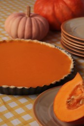 Photo of Delicious homemade pumpkin pie in baking dish on table