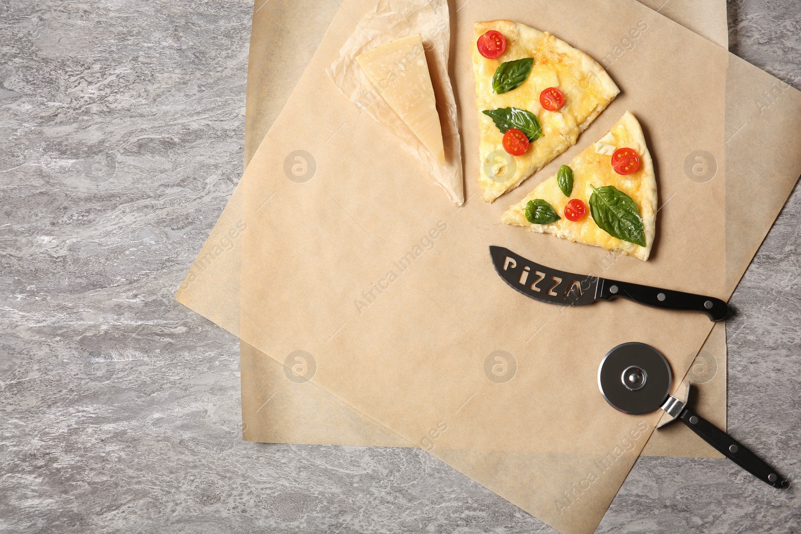 Photo of Flat lay composition with slices of tasty homemade pizza and space for text on table