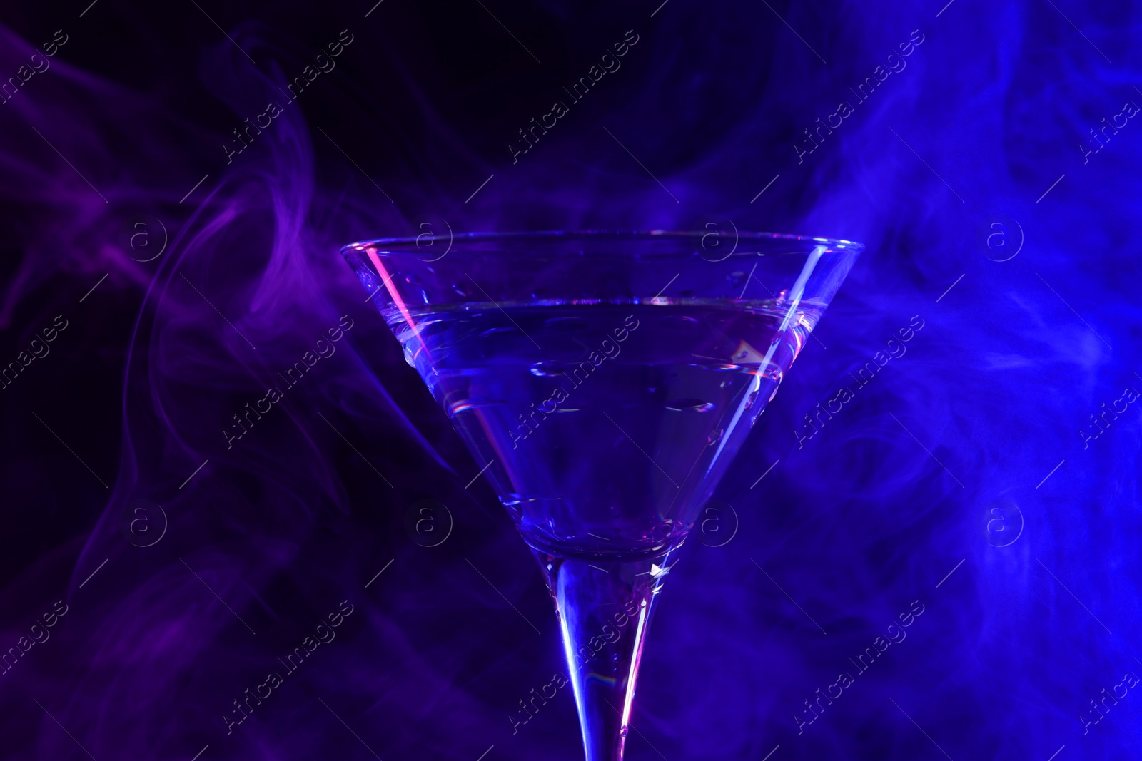 Photo of Fresh martini drink in neon lights, closeup