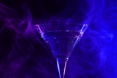 Photo of Fresh martini drink in neon lights, closeup