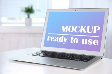 Modern laptop with text Mockup Ready To Use on screen