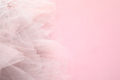 Photo of Beautiful tulle fabric on pink background, top view. Space for text