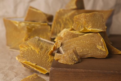 Photo of Natural organic beeswax blocks on parchment paper, closeup