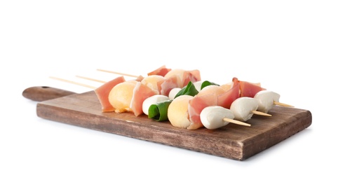 Photo of Board with melon, mozzarella and prosciutto skewers on white background