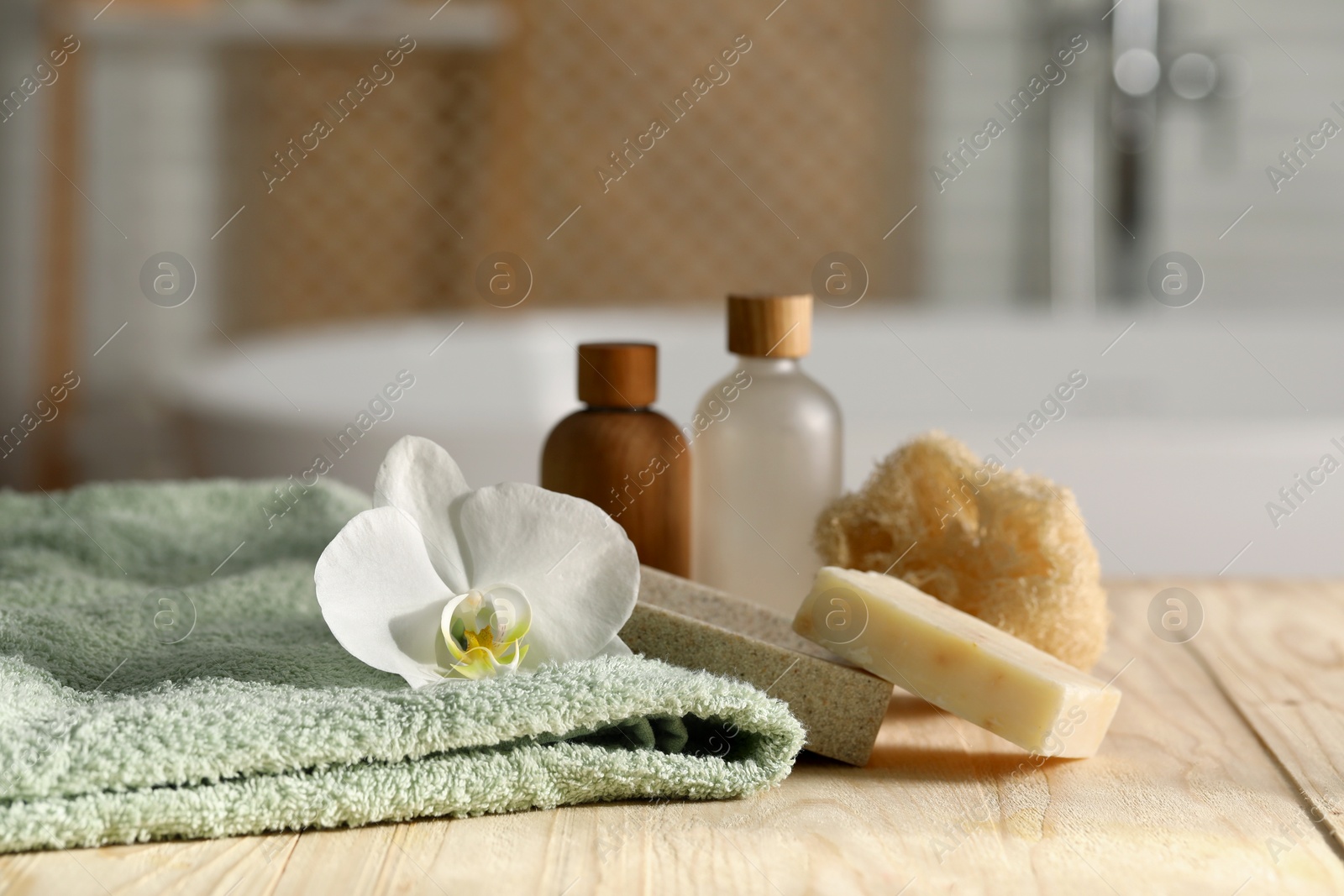 Photo of Composition with spa products on wooden table in bathroom, closeup