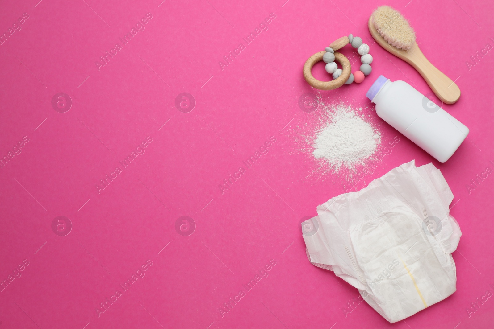 Photo of Flat lay composition with dusting powder and other baby care products on pink background, space for text