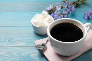 Cup of delicious chicory drink on turquoise wooden table, space for text