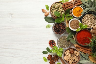 Photo of Different fresh herbs and spices on white wooden table, flat lay. Space for text
