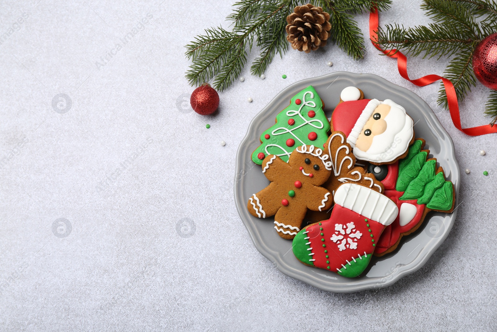 Photo of Tasty homemade Christmas cookies and decor on light grey table, flat lay. Space for text