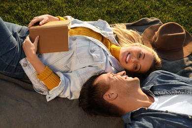Happy young couple resting while having picnic outdoors