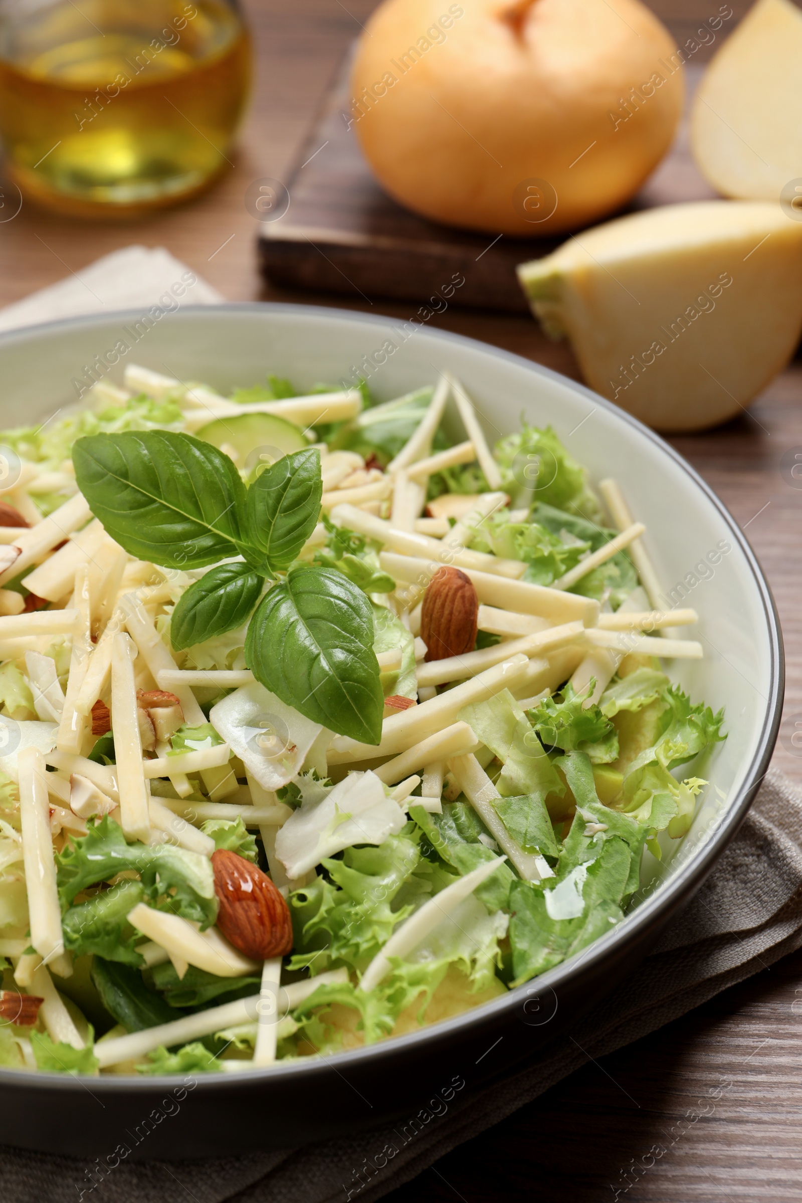 Photo of Delicious turnip salad served on wooden table, closeup