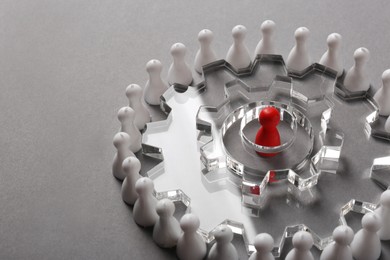 Employee selection process. Composition with cogwheels, red pawn as recruiter and white ones as applicants on light grey background. Space for text