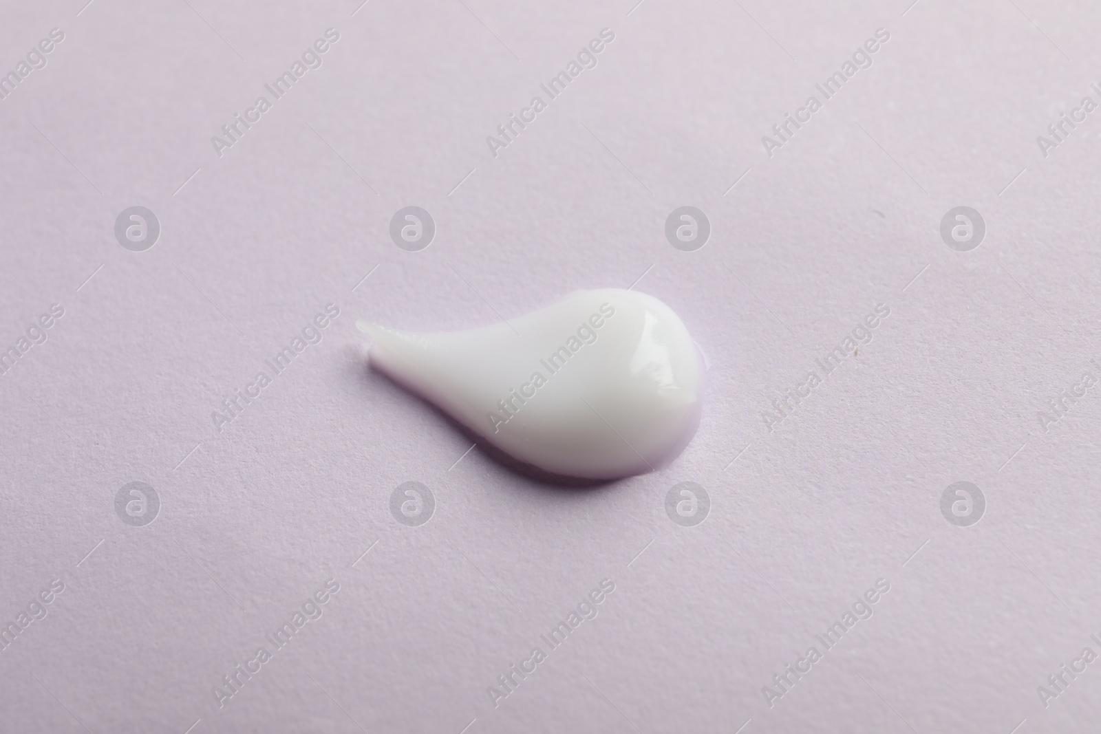 Photo of Sample of cream on pink surface, top view