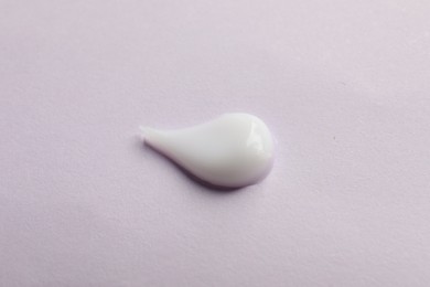 Sample of cream on pink surface, top view