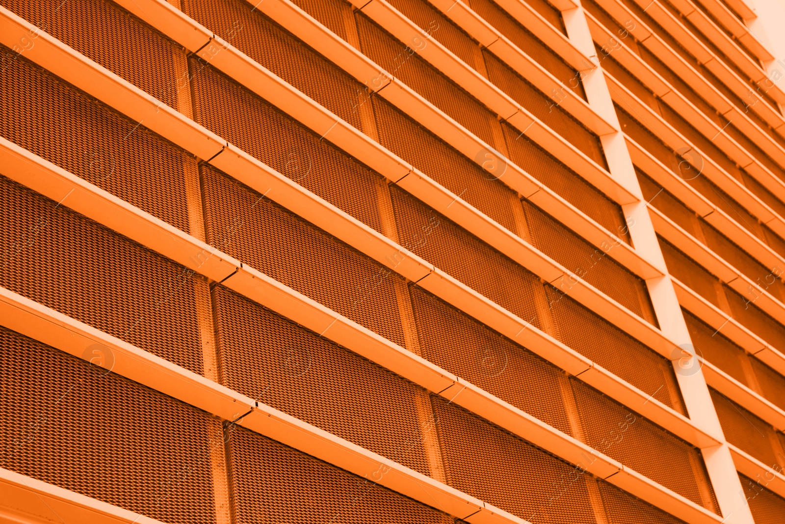 Image of Modern building, low angle view. Toned in orange color