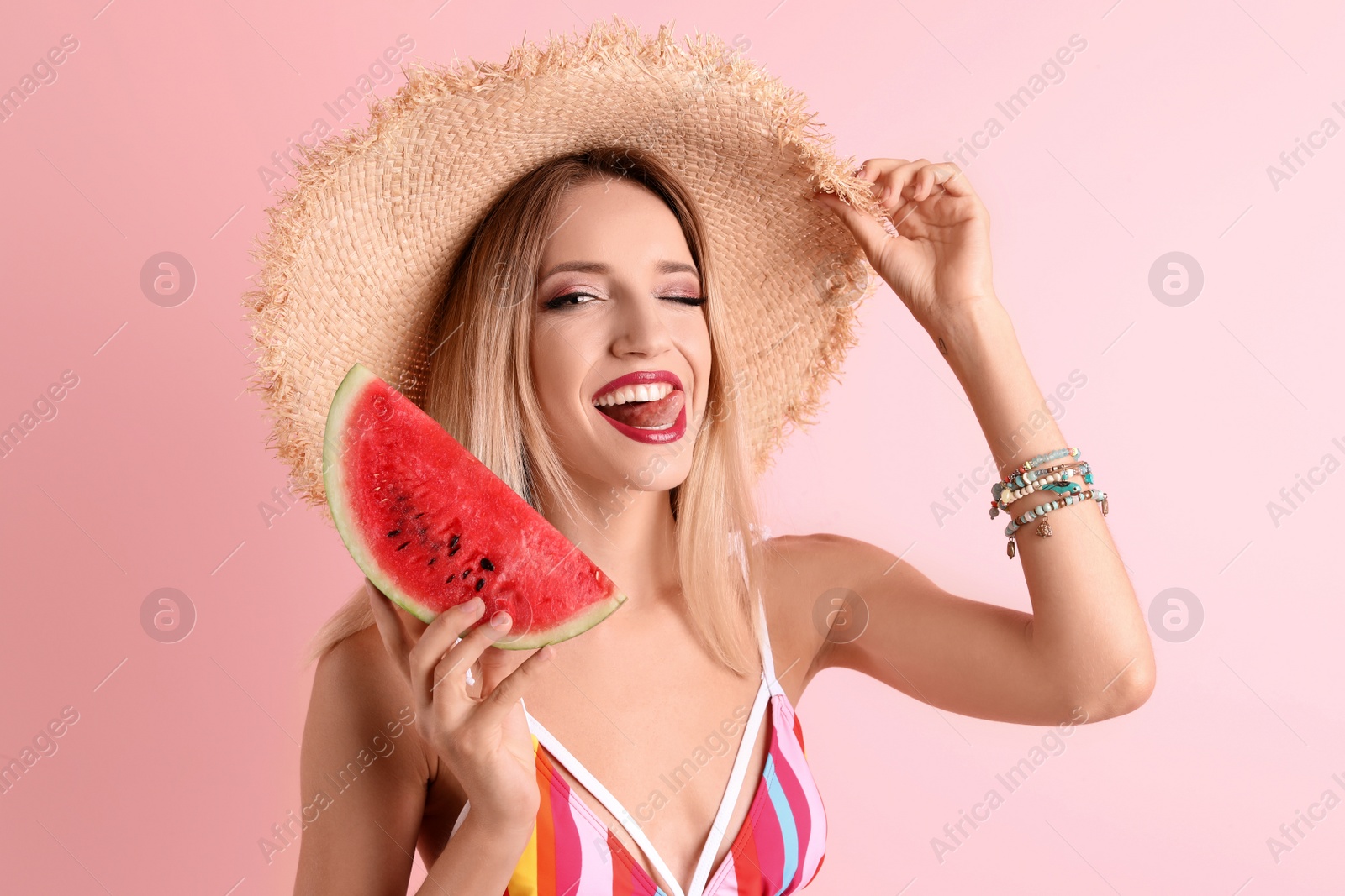 Photo of Pretty young woman with juicy watermelon on color background