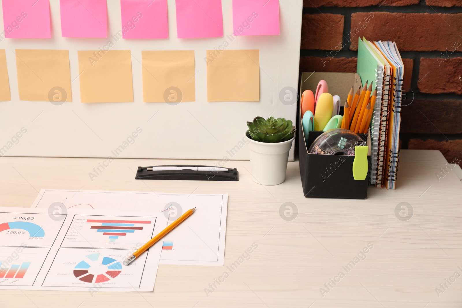 Photo of Business process planning and optimization. Workplace with colorful paper notes and other stationery on table