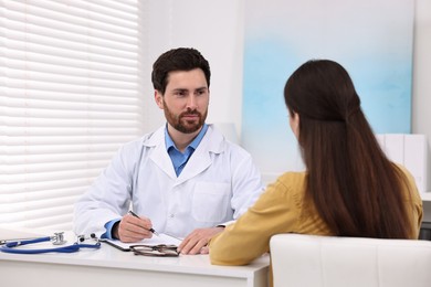 Doctor consulting patient during appointment in clinic