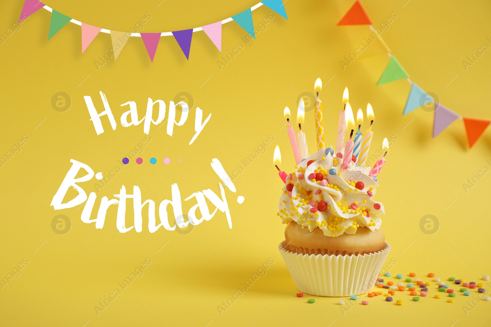 Image of Happy Birthday! Delicious cupcake with candles on yellow background
