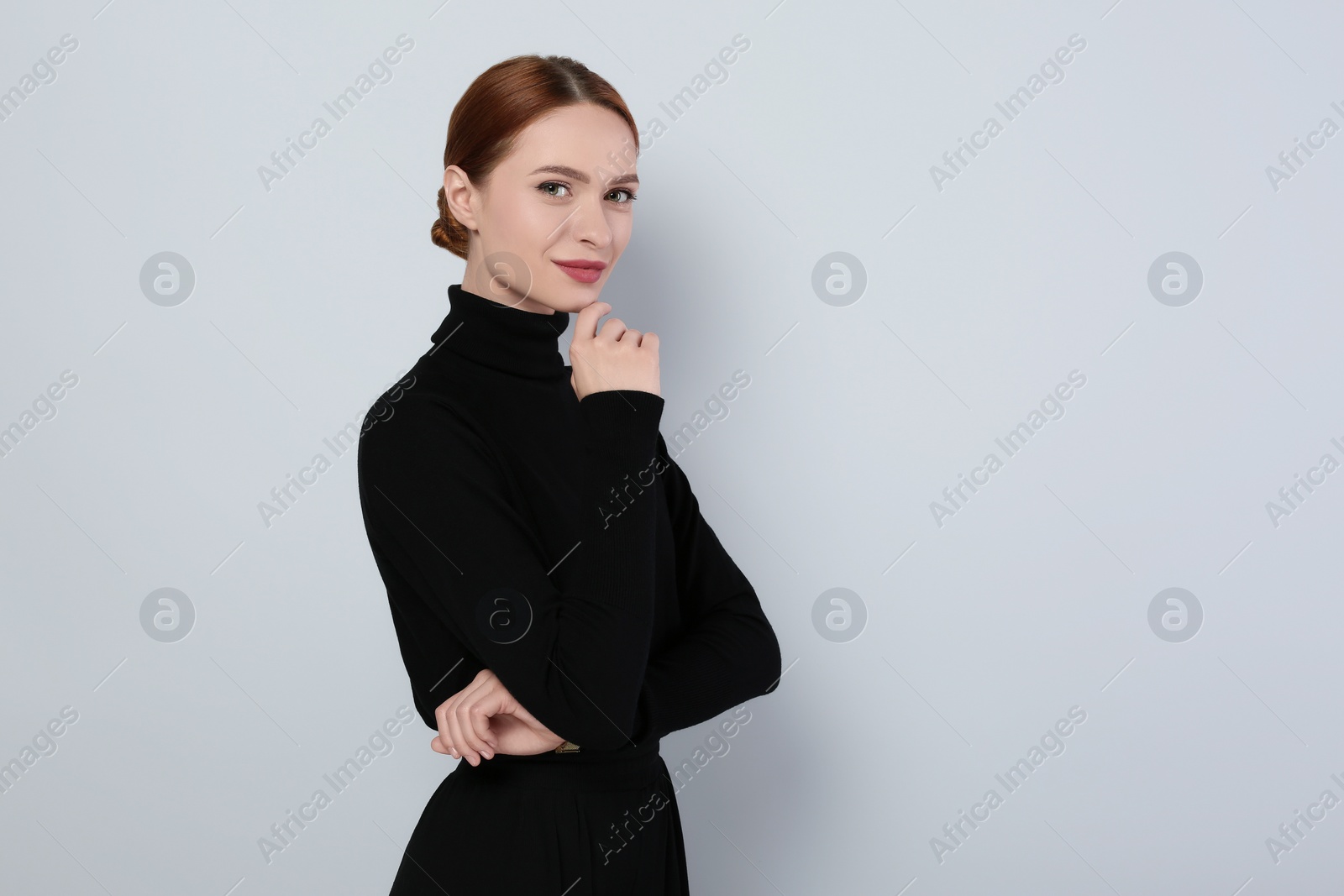 Photo of Portrait of beautiful young woman on light gray background, space for text