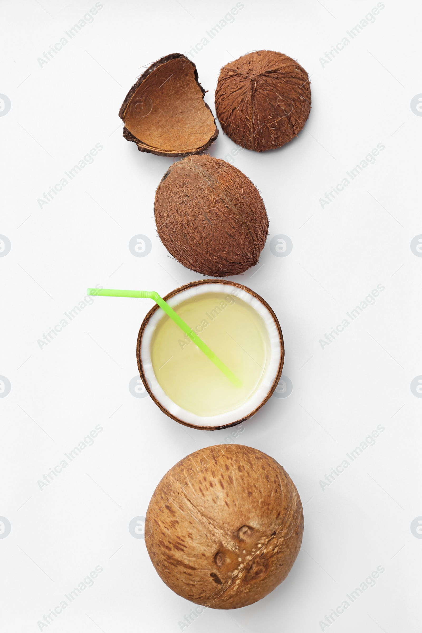 Photo of Composition with drink in half of coconut on white background, top view