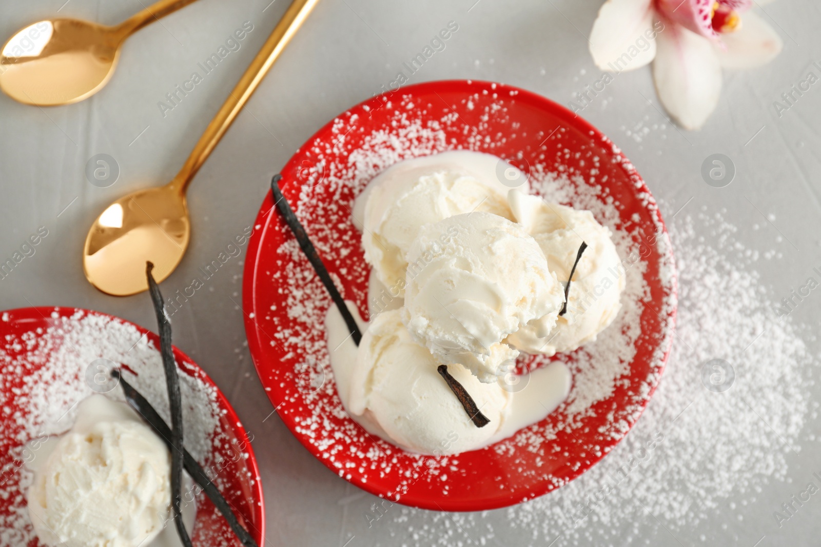Photo of Plate with tasty vanilla ice cream on grey background, top view