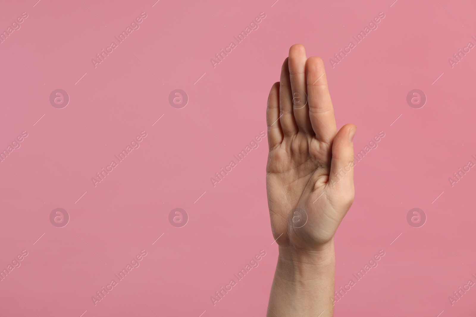 Photo of Woman giving high five on pink background, closeup of hand. Space for text