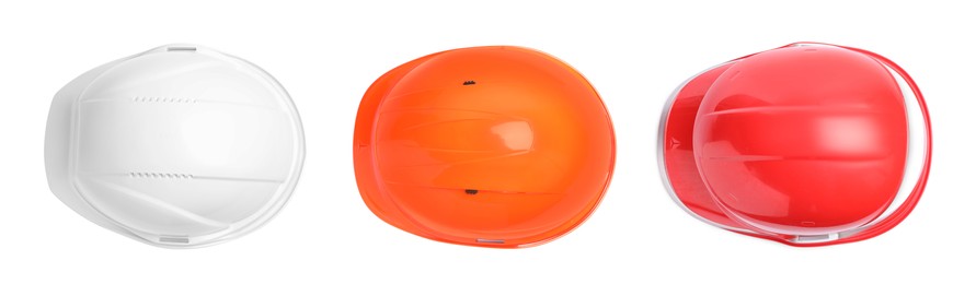 Set with different hard hats on white background, top view. Safety equipment