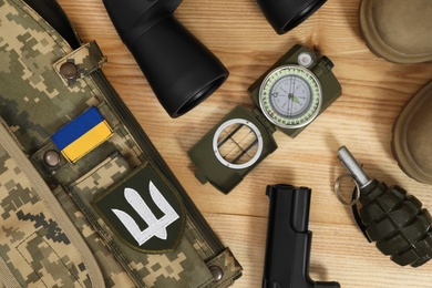 MYKOLAIV, UKRAINE - SEPTEMBER 26, 2020: Tactical gear and Ukrainian military uniform on table, flat lay