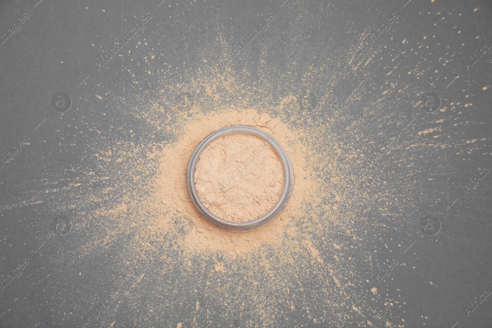 Photo of Loose face powder on grey background, flat lay