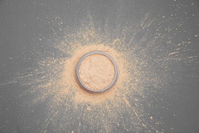 Loose face powder on grey background, flat lay