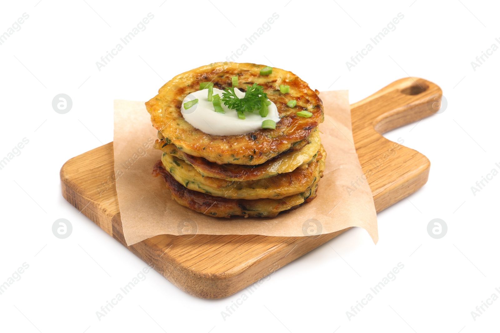 Photo of Delicious zucchini fritters with sour cream on white background