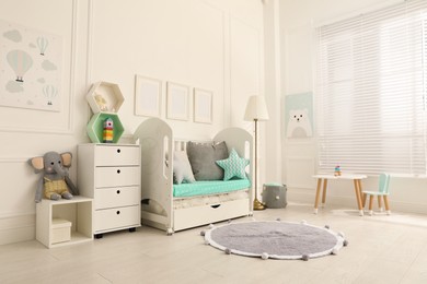 Cozy baby room interior with crib and toys