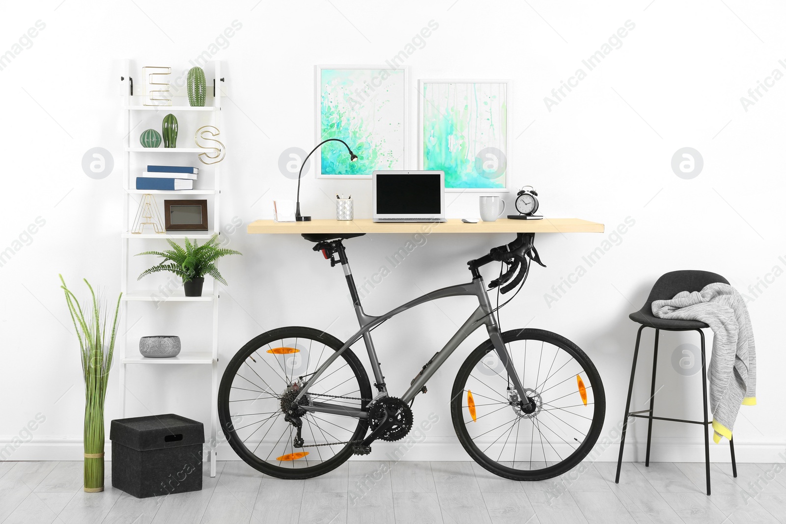 Photo of Modern home office interior with bicycle near wall