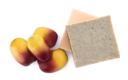 Fresh ripe palm oil fruits and soap bars on white background, top view