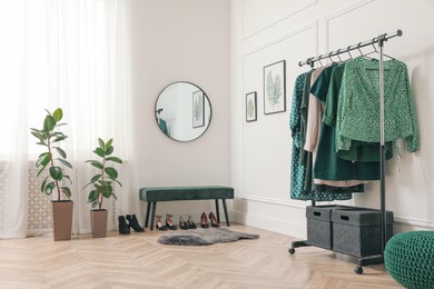 Photo of Modern room with clothes rack and mirror. Interior design