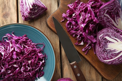 Photo of Flat lay composition with shredded red cabbage on wooden table