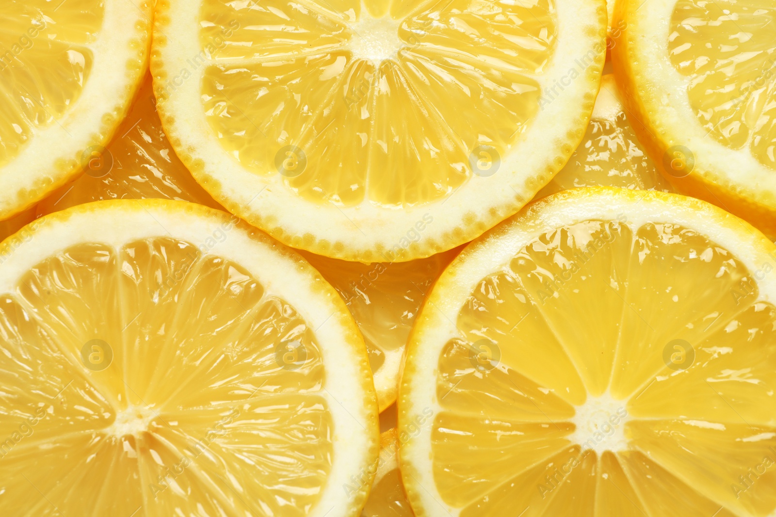 Photo of Juicy lemon slices as background, top view. Citrus fruit