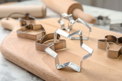 Photo of Cutters for homemade Christmas cookies on wooden board