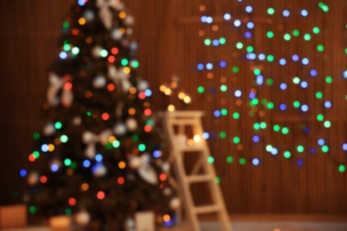 Photo of Blurred view of stylish room interior with decorated Christmas tree