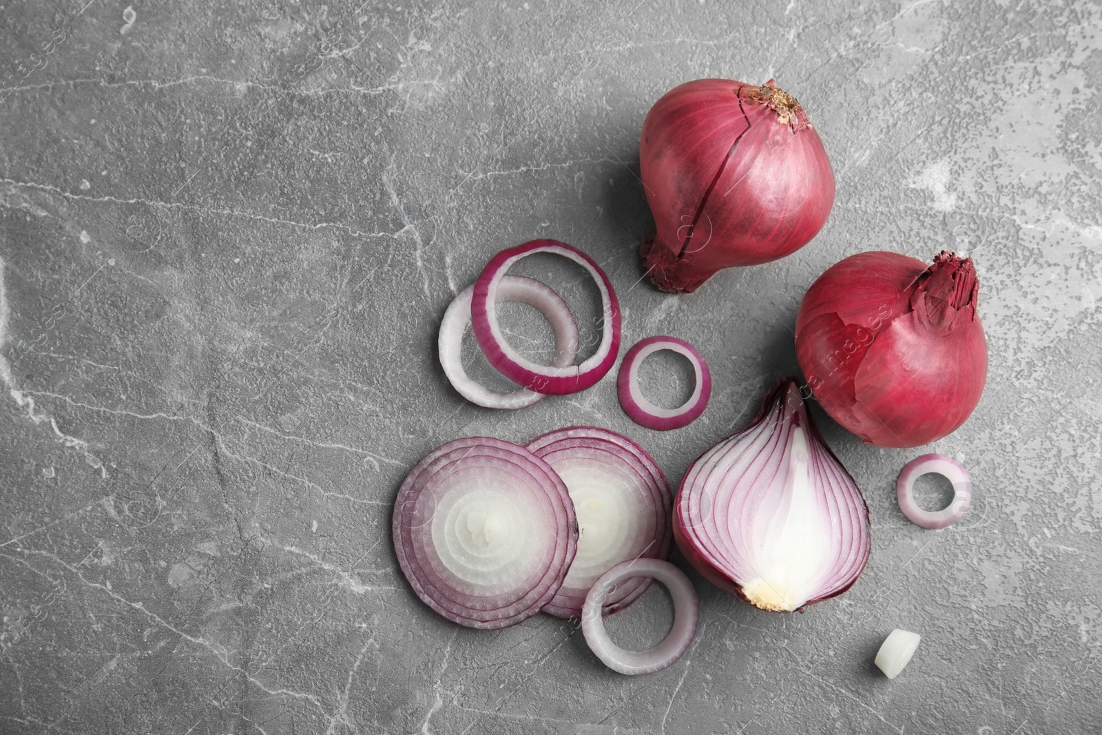 Photo of Ripe red onions on table, top view