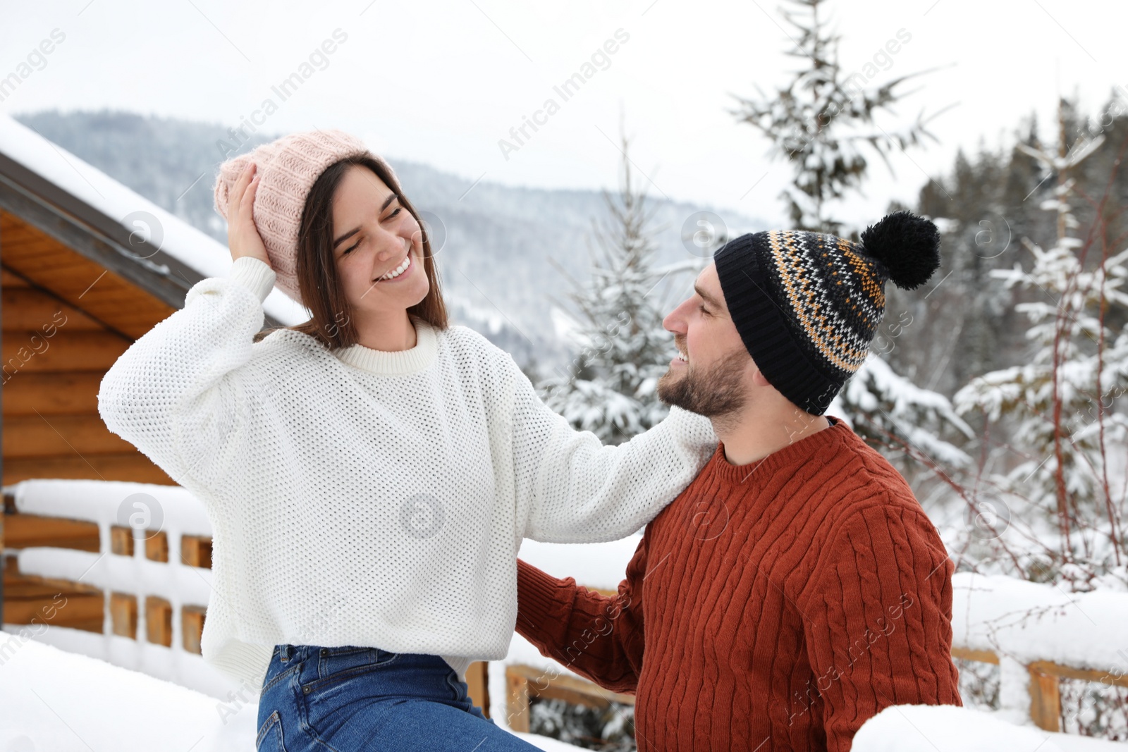 Photo of Happy couple in warm sweaters outdoors on winter day