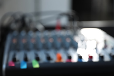 Photo of Blurred view of modern audio mixing console