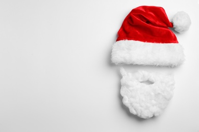 Santa Claus hat with beard on white background, top view